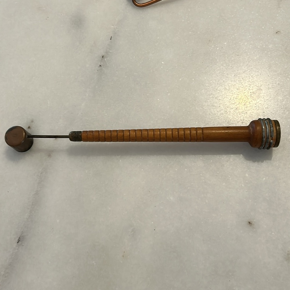 Vintage candle snuffer made from a wooden spool